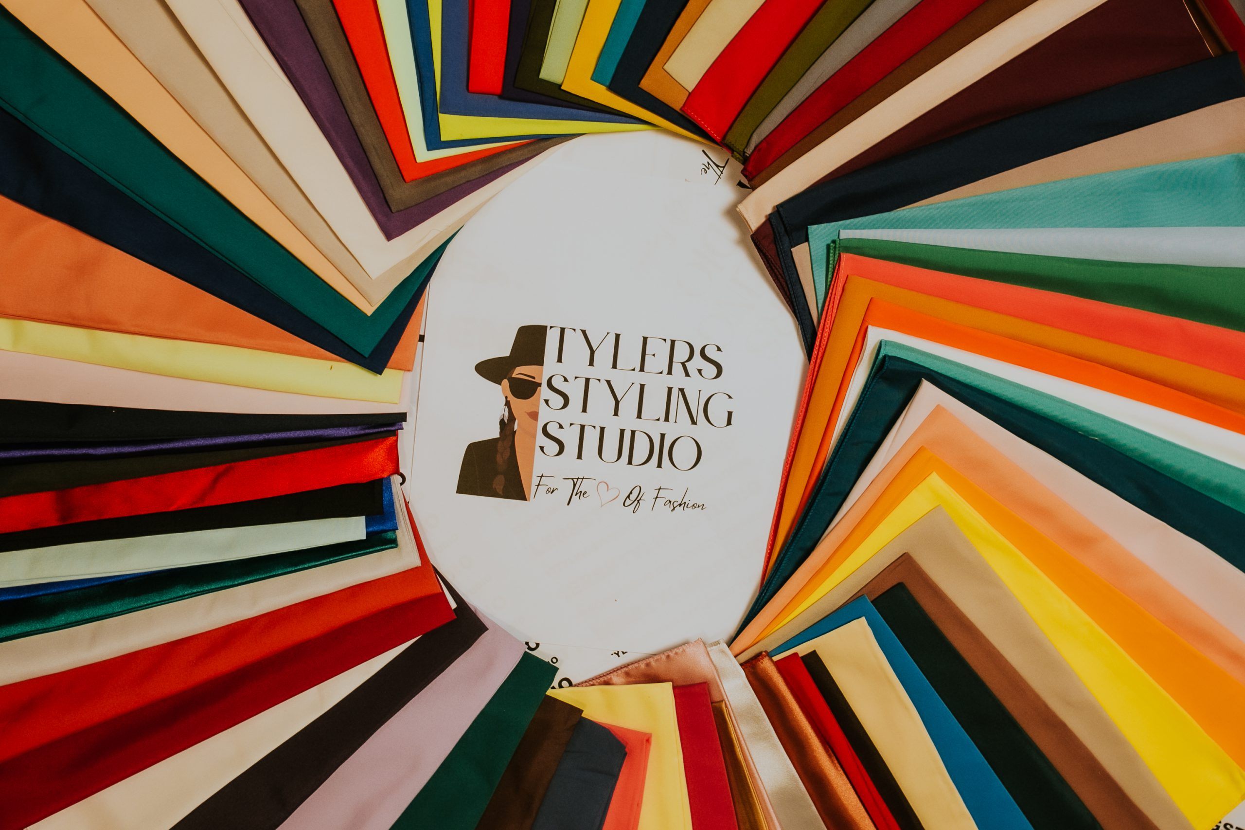 Tyler's Styling Studio logo surrounded by a fan of color analysis drapes